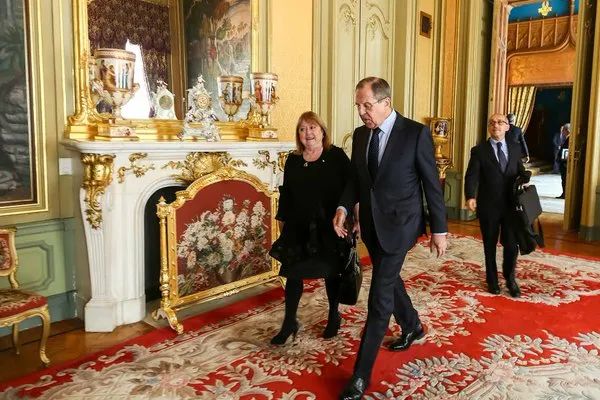 Argentine Foreign Minister Susana Malcorra walking down a gilded hallway with Sergey Lavrov in Moscow