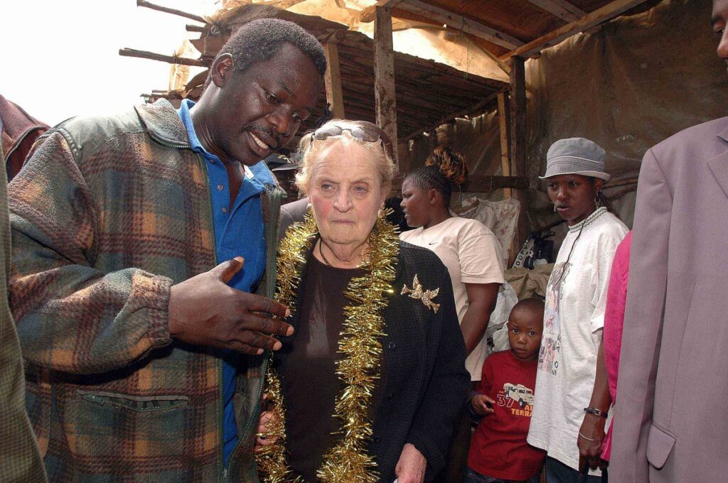 Photo of two people posing in front of a market in Nairobi.