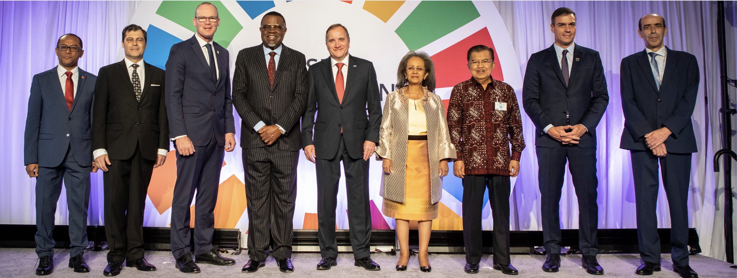 Row of UN leaders smiling at camera