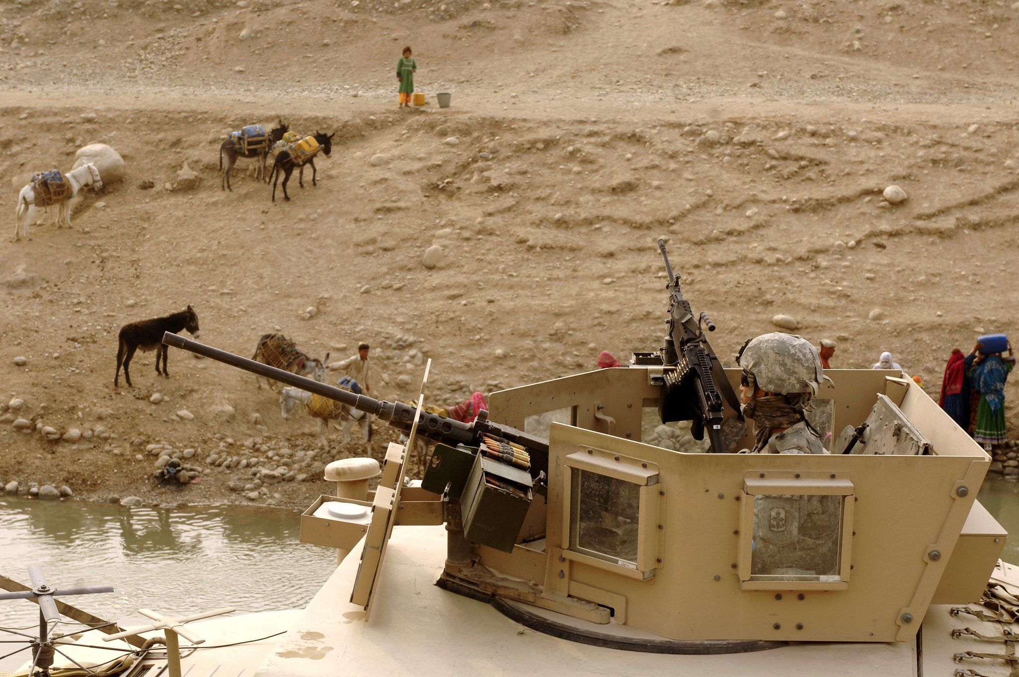 Military person in a tank in the desert