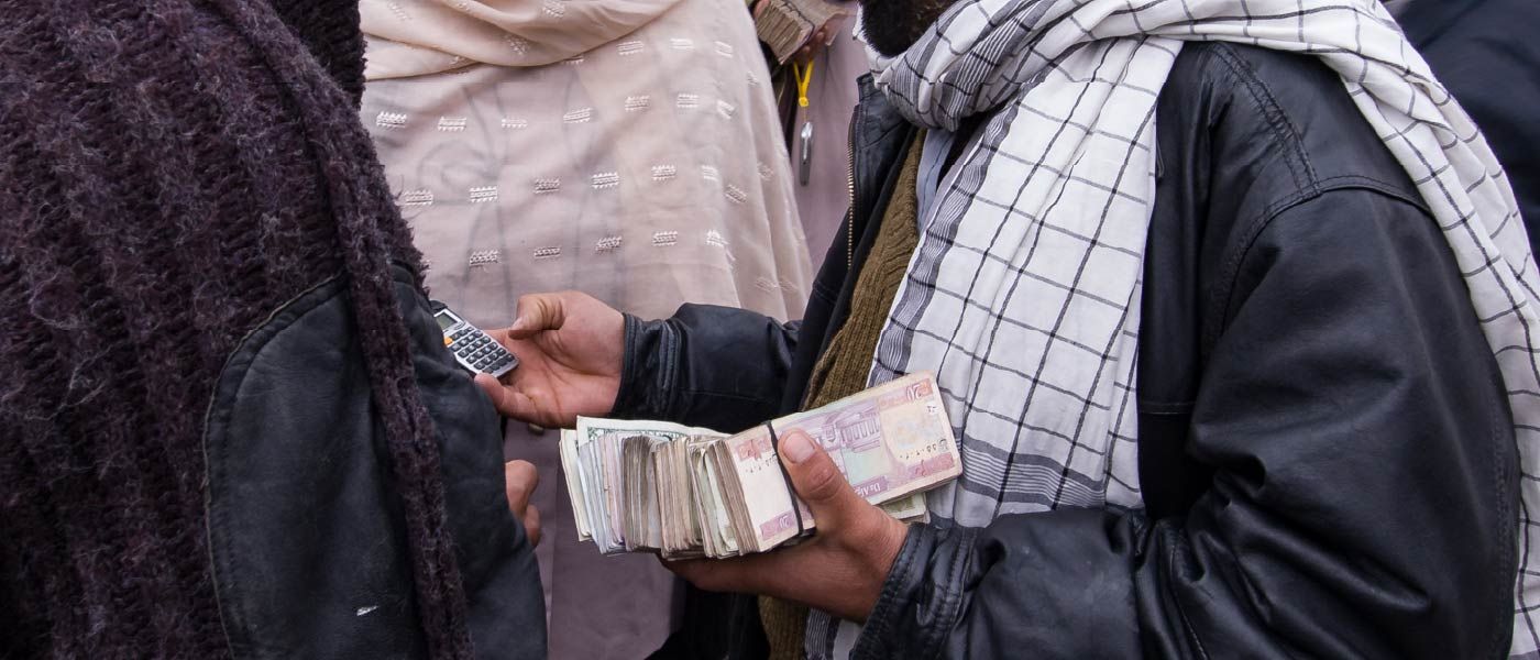 Someone holding foreign currency and calculator