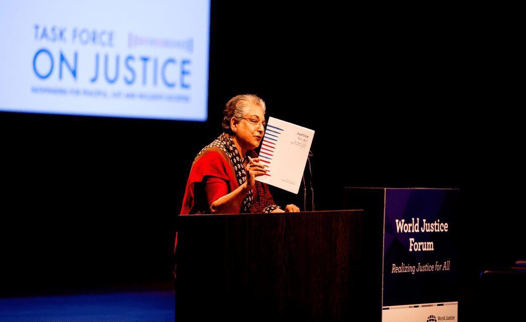 Woman speaking at podium at World Justice Forum