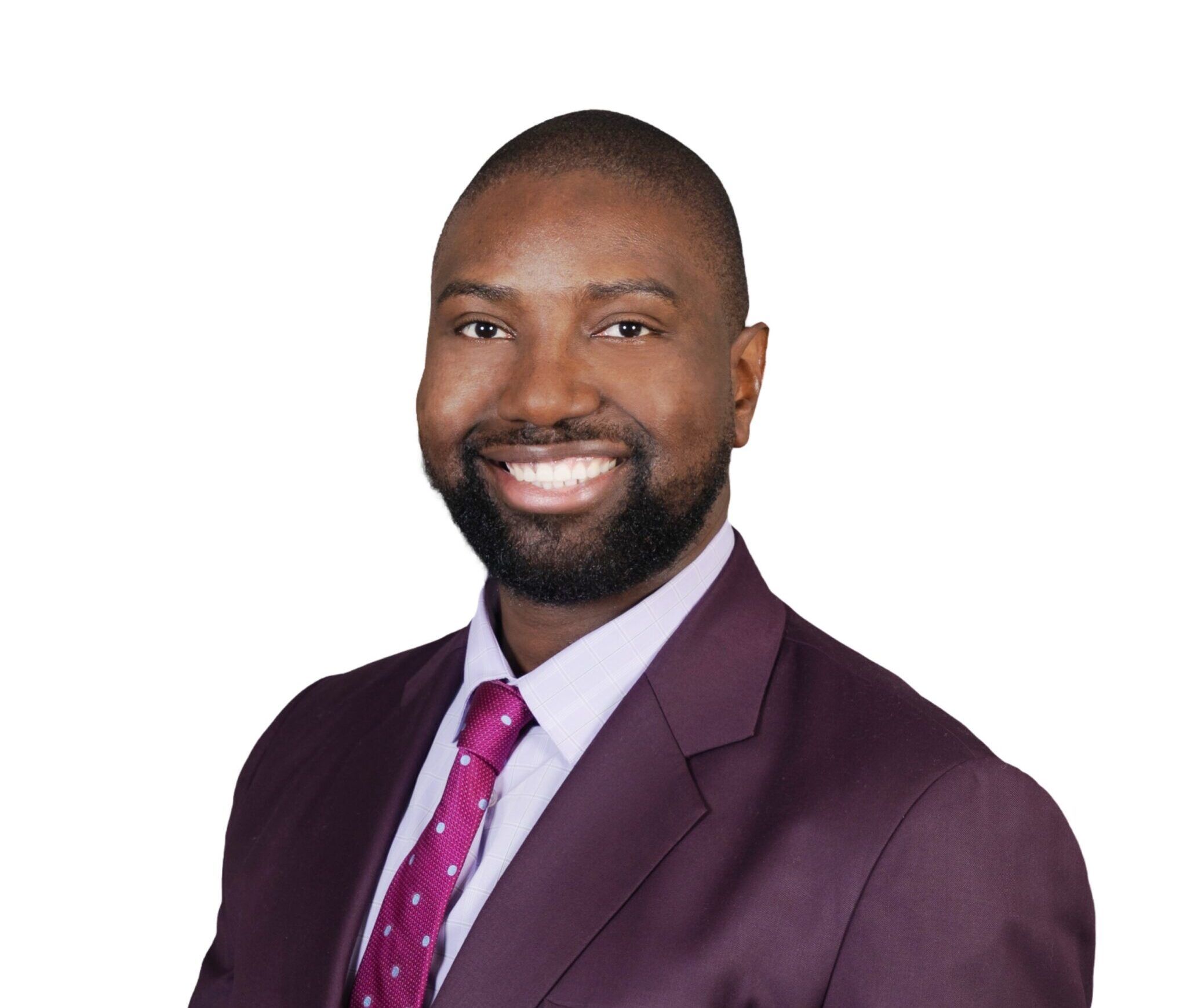 Headshot of a person wearing a purple suit and red tie with white background.