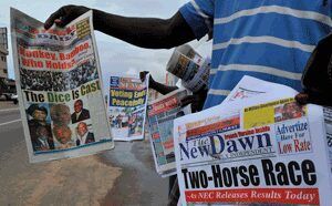 African man holding up newspaper