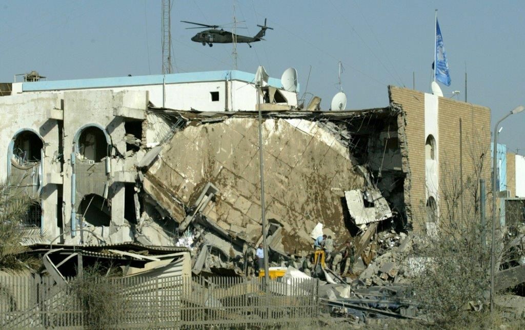 Helicopter flies over destroyed building