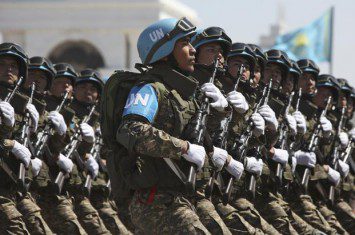 UN peace officers marching with guns