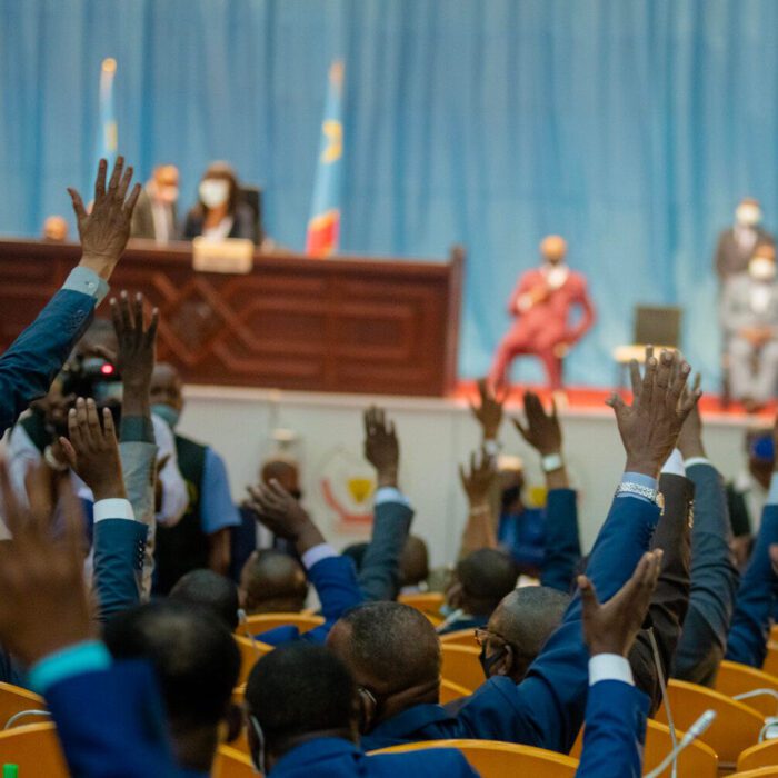 Crowd raising hands at a conference