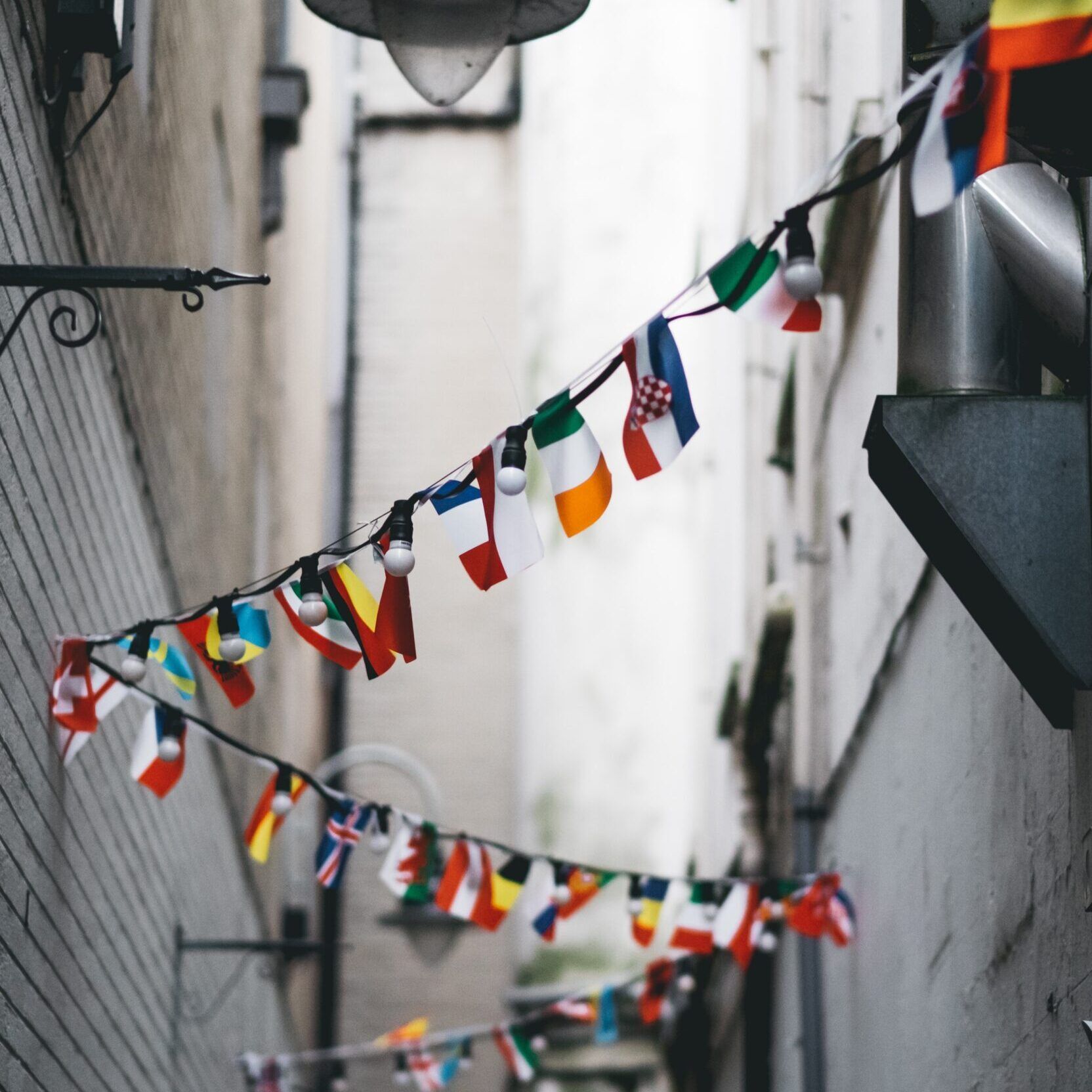 Flags and lights hanging in an alley