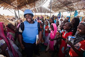 Ghanaian police officer Mary Sebastian of the African Union-United Nations Hybrid Operation in Darfur (UNAMID) with school children at the El Sereif camp for internally displaced persons (IDPs), located west of Nyala, South Darfur. 8 May 2014
