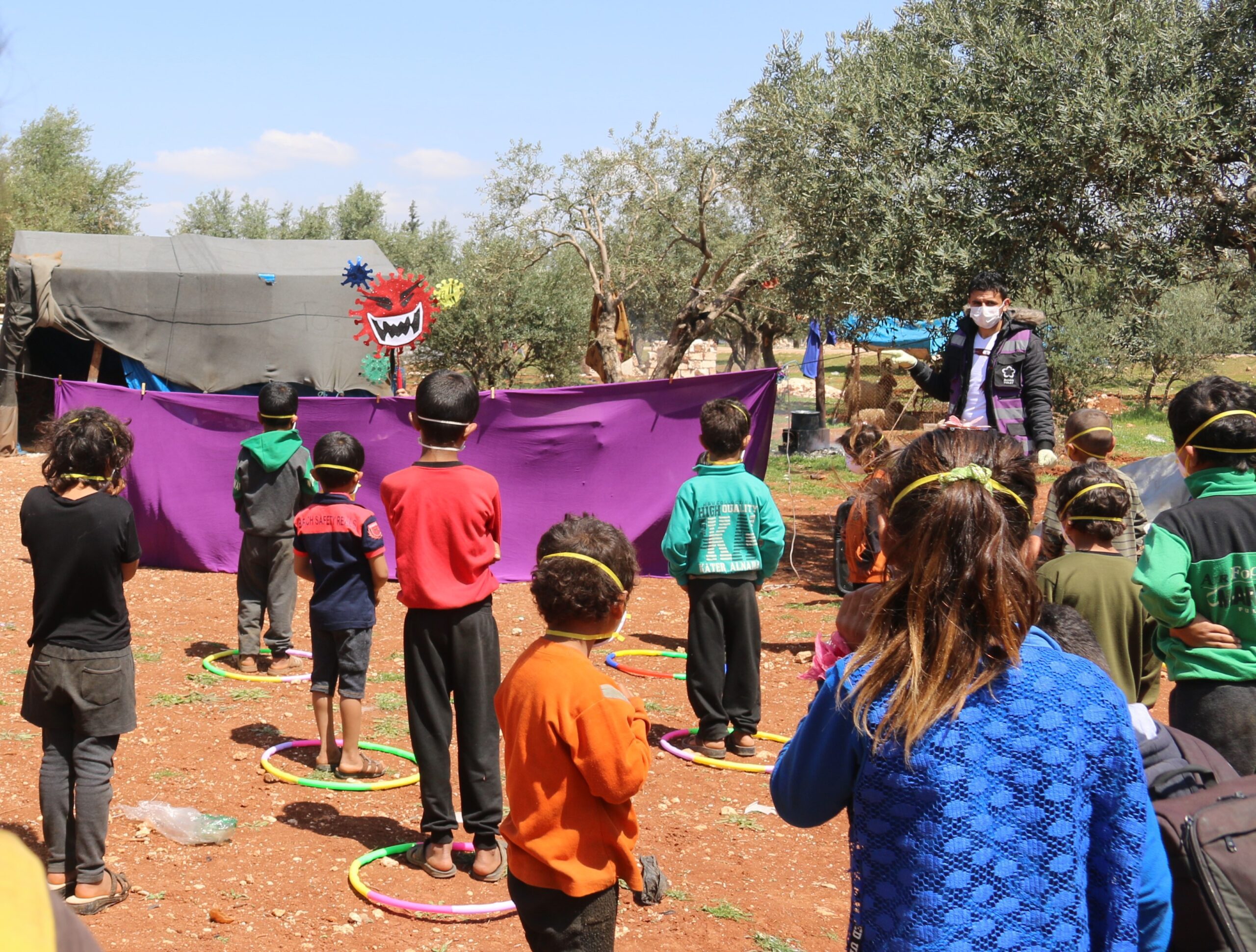 Children gather for an event to raise awareness about COVID-19 in Idlib province.