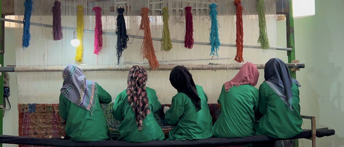 Four Afghani women weaving