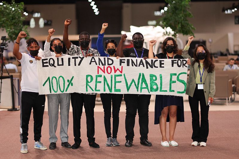 Group of protesters holding a sign at COP28