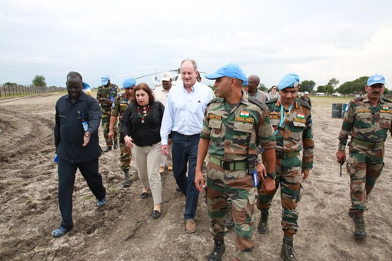 UN peacekeepers in Akobo, South Sudan walking with the SRSG on a dirt road.