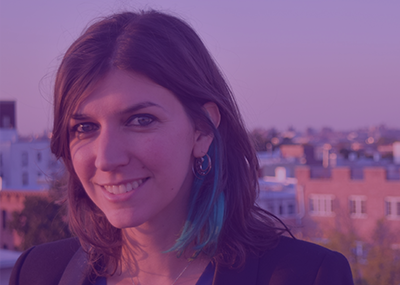 Headshot of a person with short brown hair under a purple gradient.