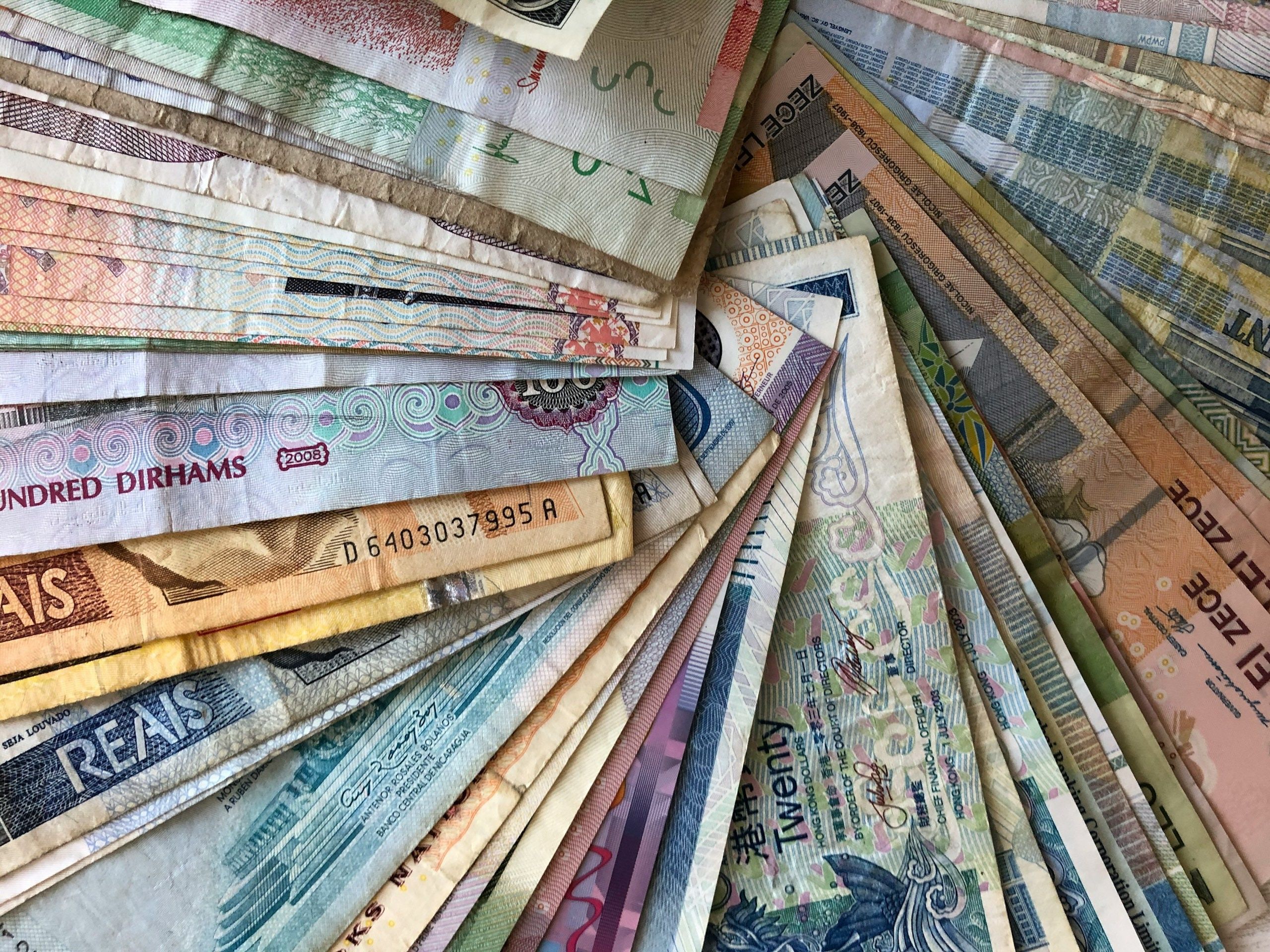 Different types of currency arranged in a fanned out layout.