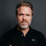 Headshot of a person wearing a collared shirt