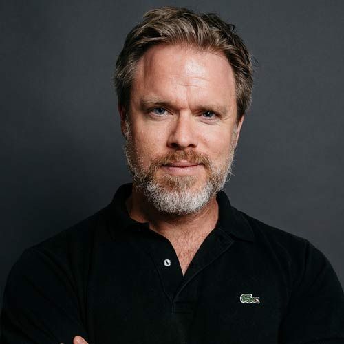 Headshot of a person wearing a collared shirt