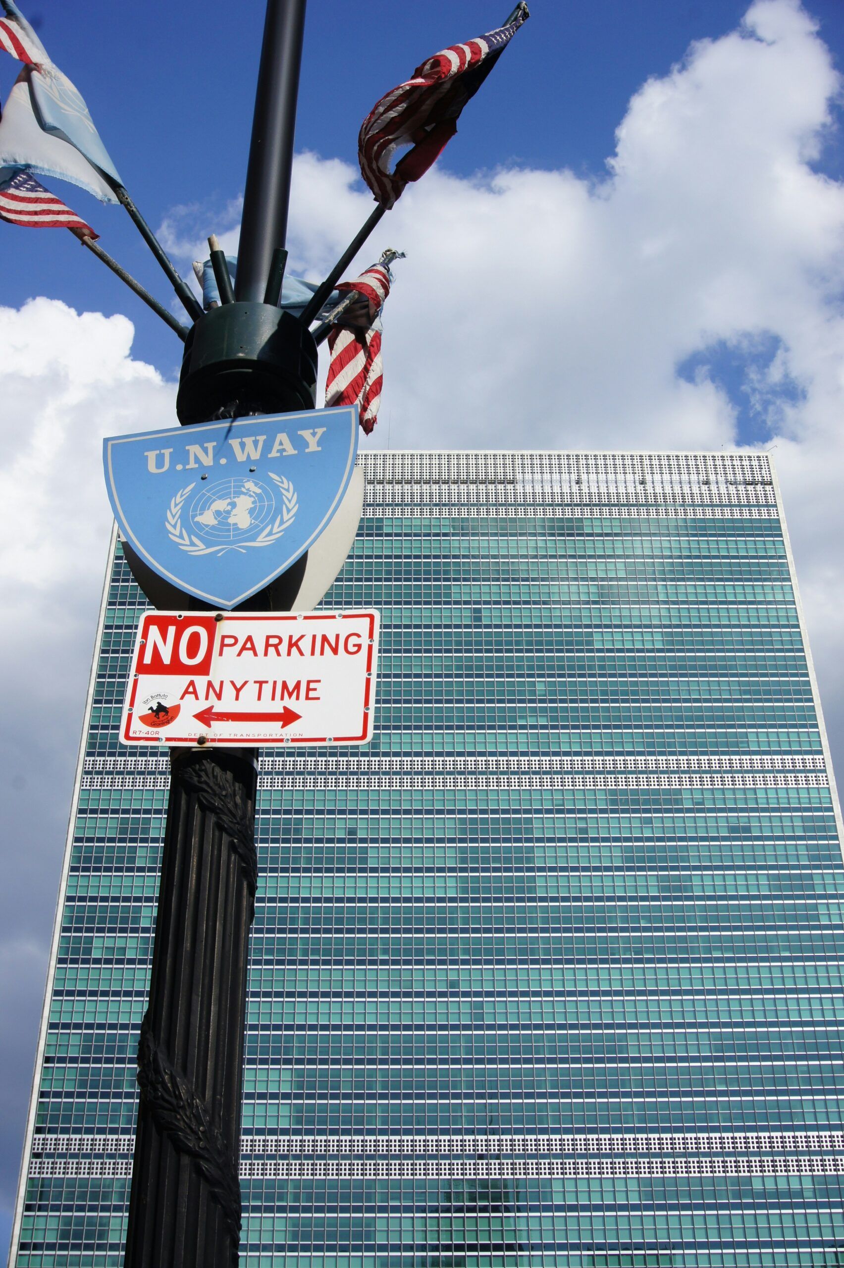Photo of flags on a street pole, along with a 
