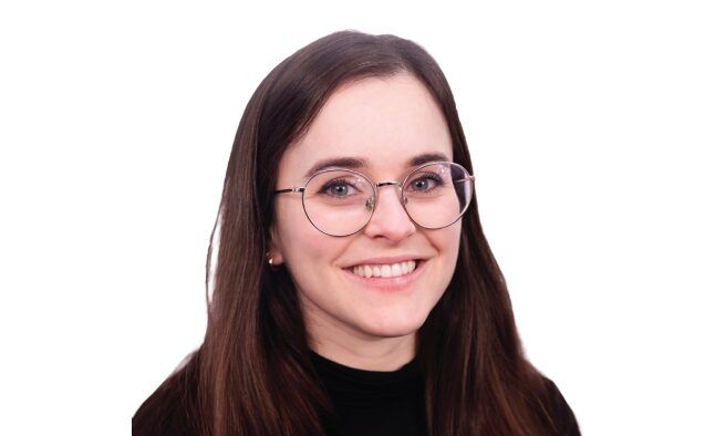 Headshot of a person wearing glasses with long brown hair.