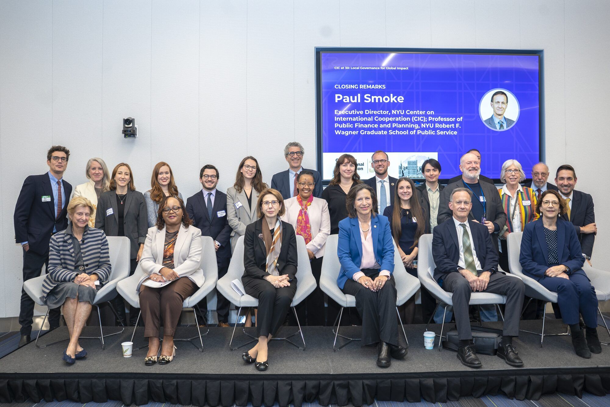 Group photo in two rows - one seated, and one standing.