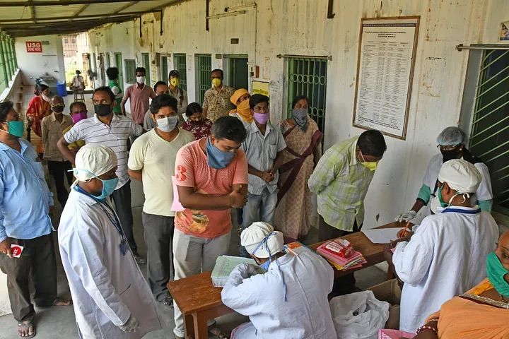 Photo of people lining up with masks on.