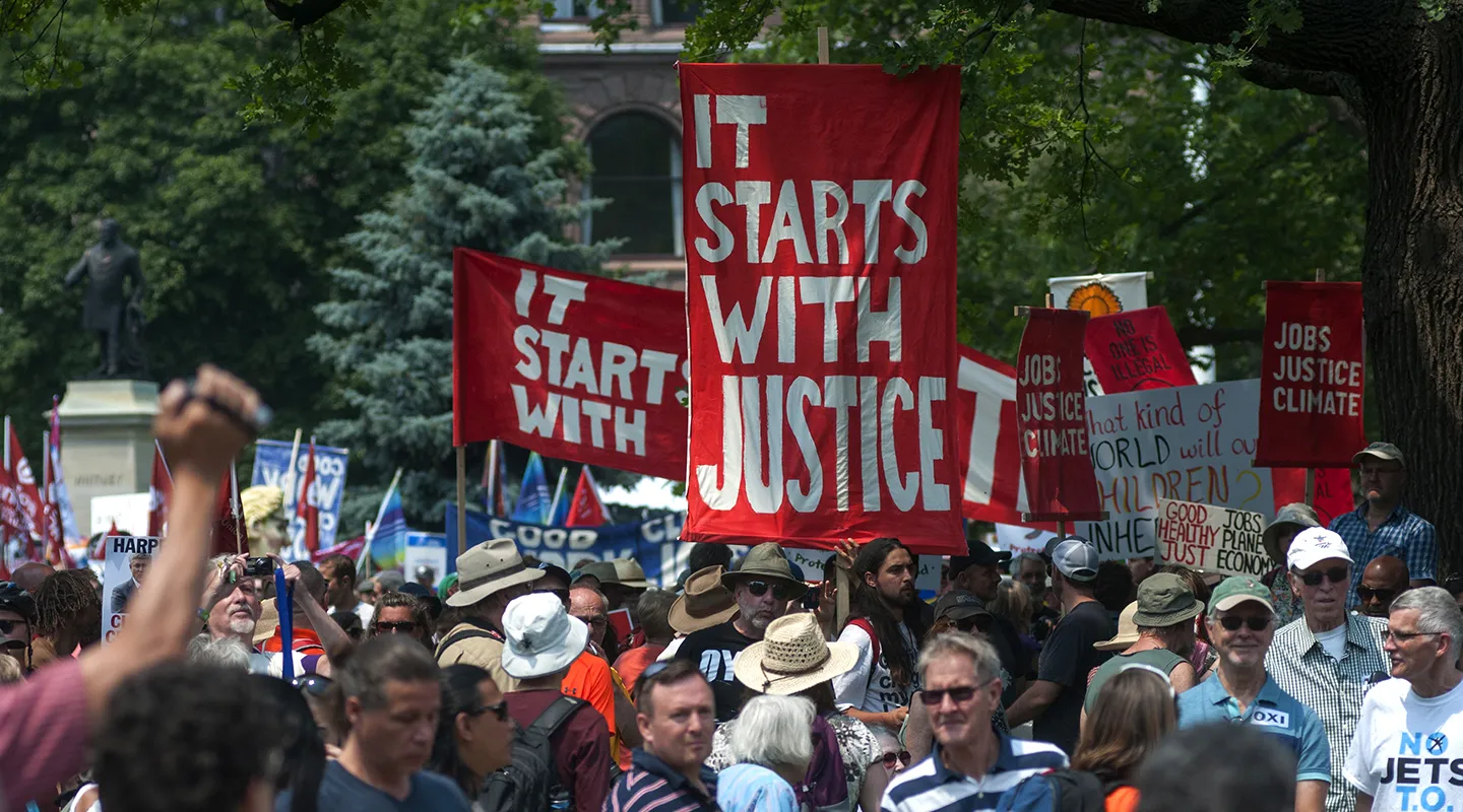 crowd marching with justice banners