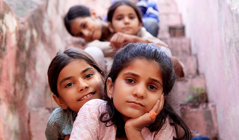 foreign children sitting on concrete steps