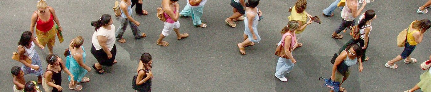 Aerial shot of a crowd of women walking along asphalt