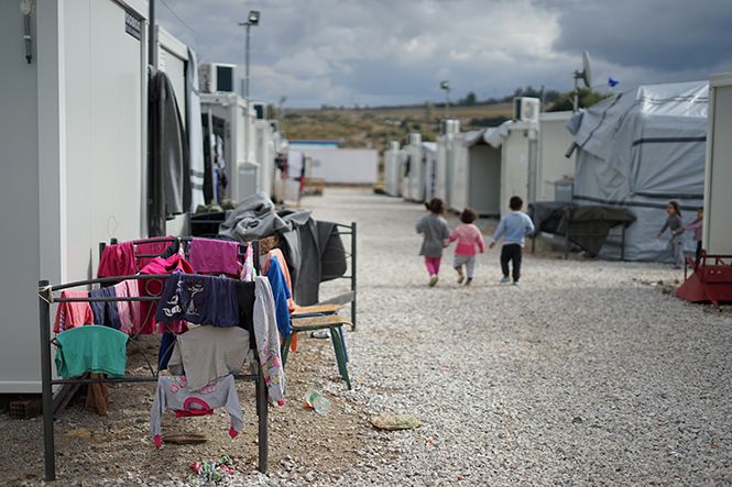 small children walking through refugee camp