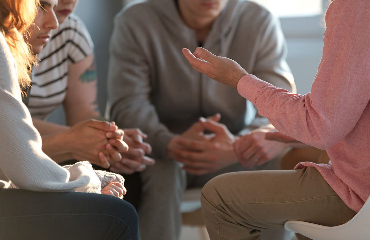 closeup shot of hands in a support group circle