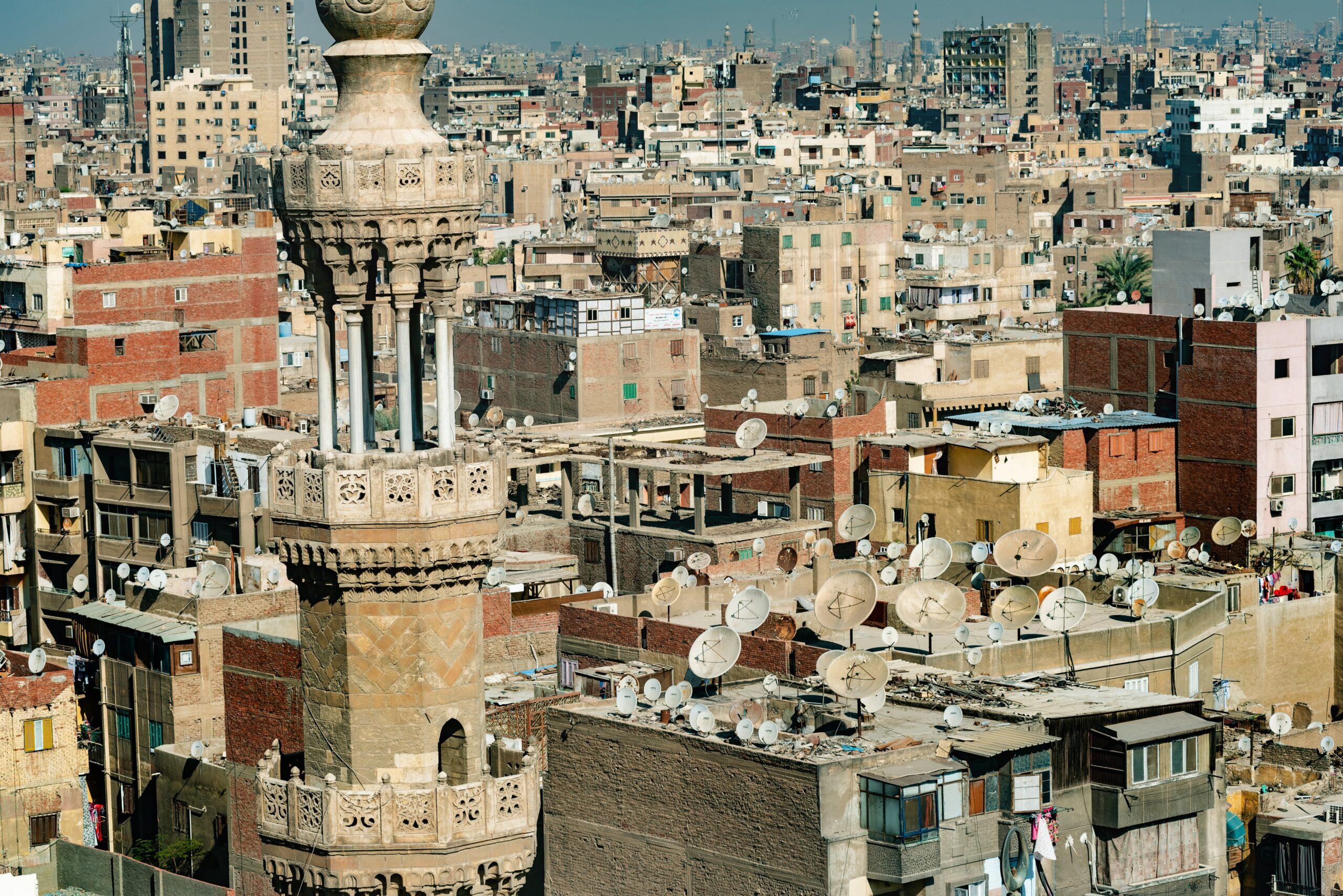 Islamic mosque minaret in front of crowded aerial cityscape view of Cairo, the densely populated capital of Egypt, Africa