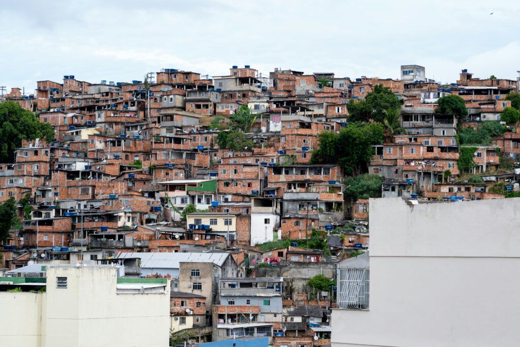 Stacked informal favela dwellings on the side of a hill landscape photo.