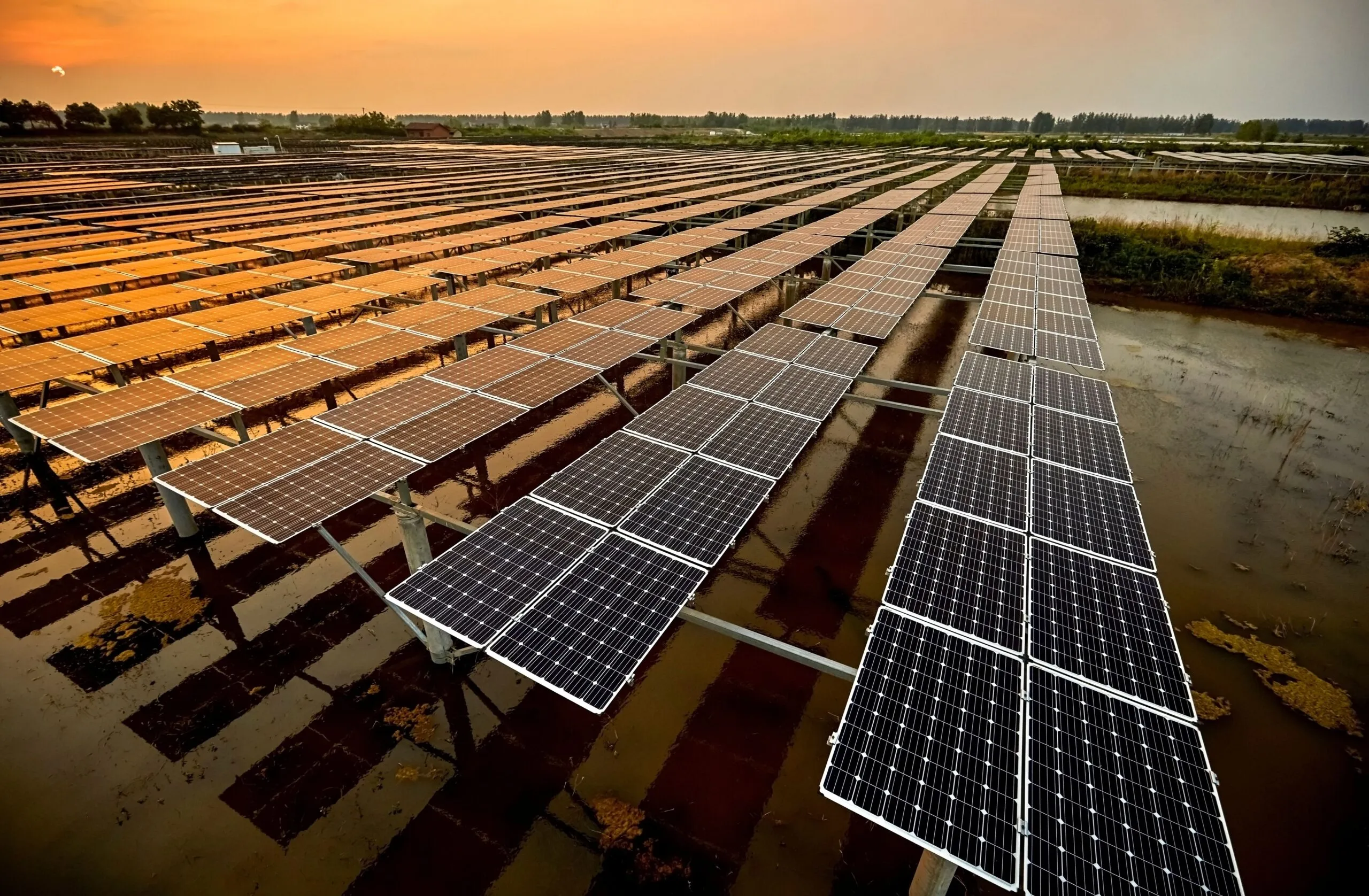 Aerial outdoor solar photovoltaic base in Asia under sunset.